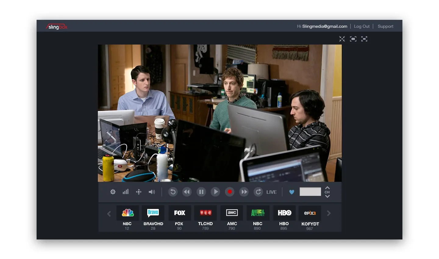 SlingPlayer with the sidebar closed: a TV scene of three people at computers, transport controls beneath it and a row of channel tiles.